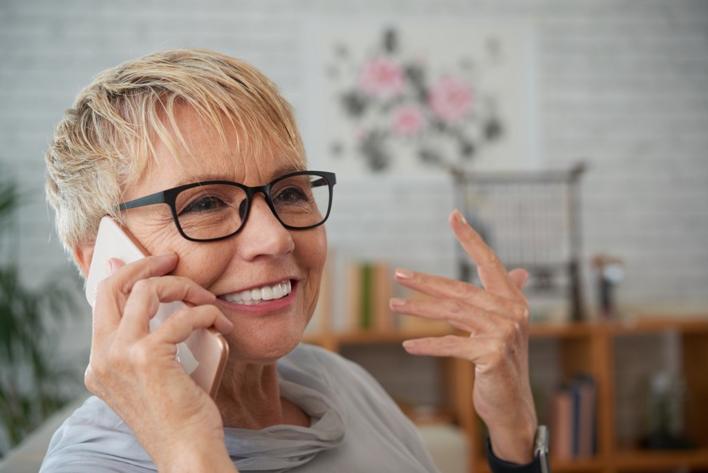 Smiling old woman talking on phone